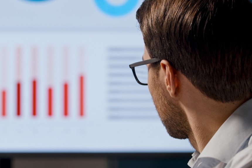 Man In Glasses Looking At A Computer